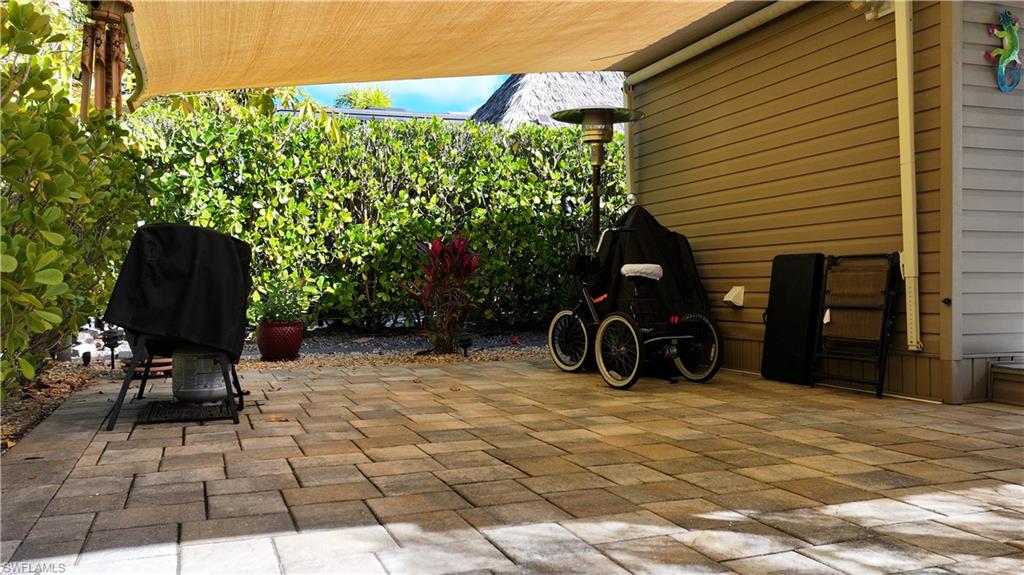View of patio with a grill