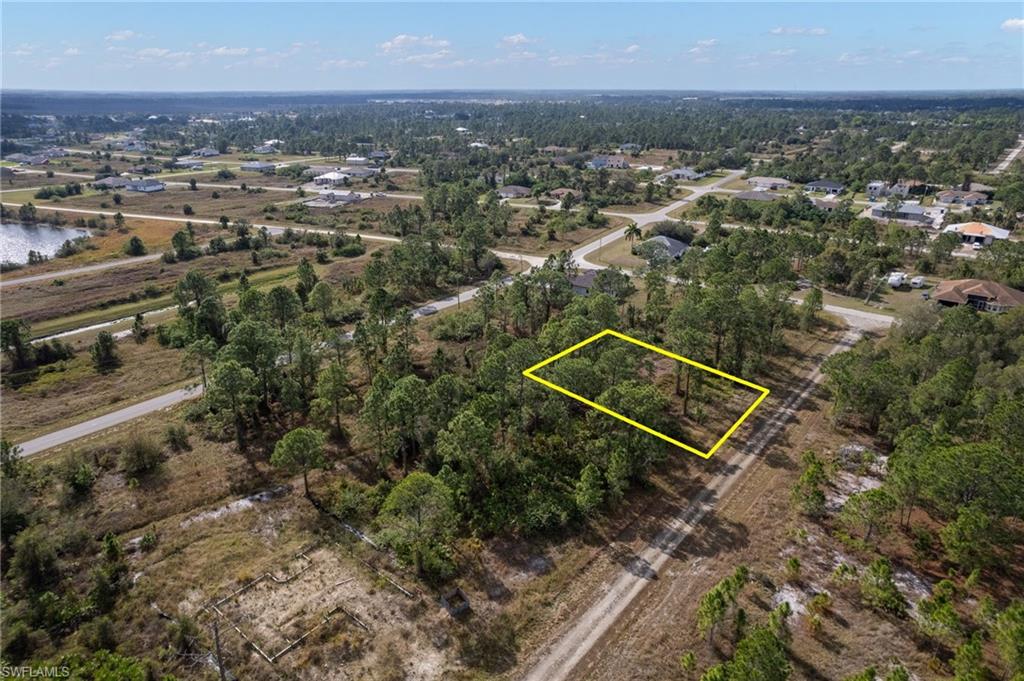 Aerial view of property and surrounding area with property boundaries highlighted and a large body of water