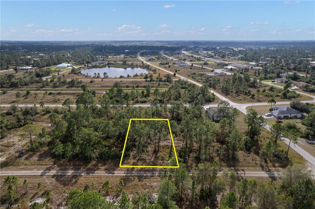 Aerial overview of property's location featuring property parcel outlined and a large body of water