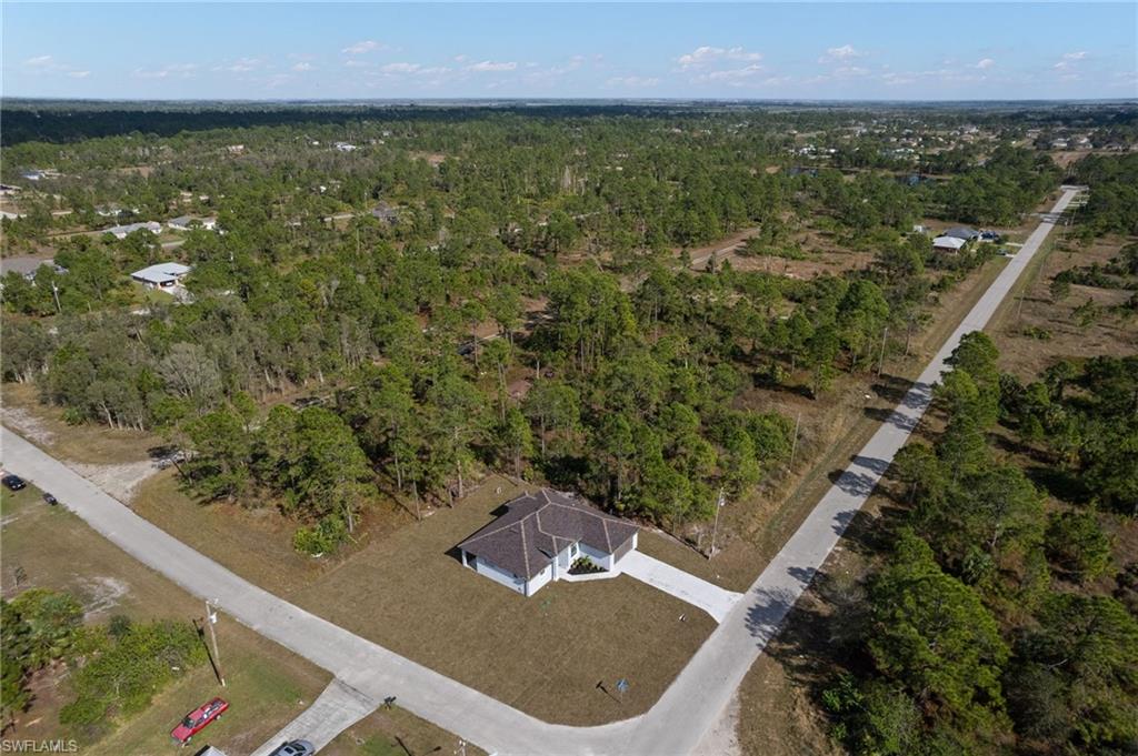 Aerial view of property's location with a heavily wooded area