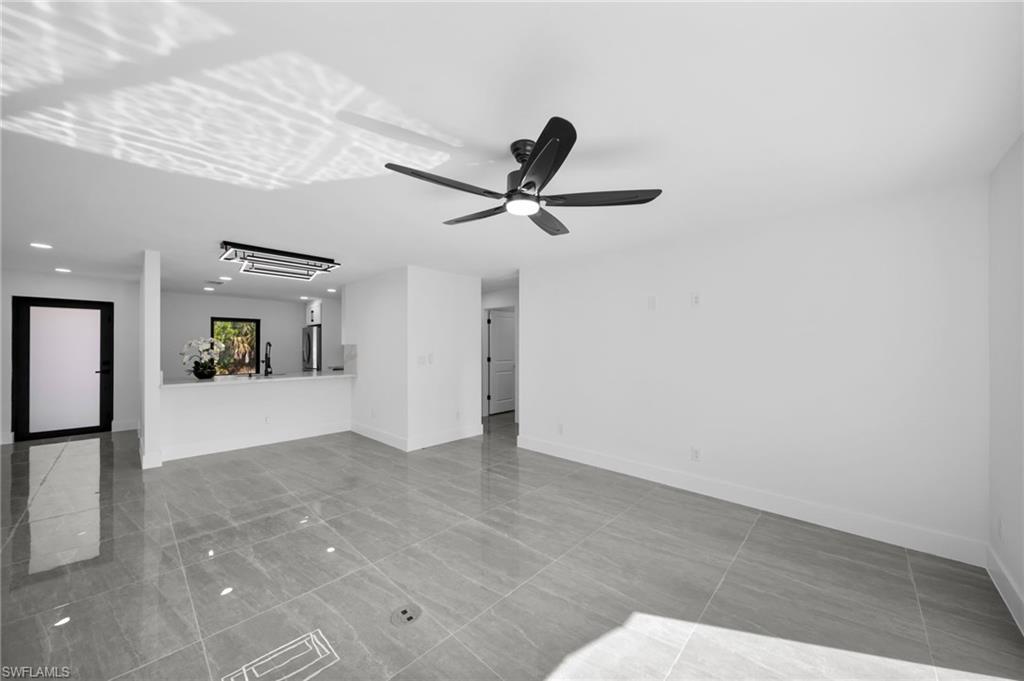 Unfurnished living room featuring a ceiling fan and recessed lighting