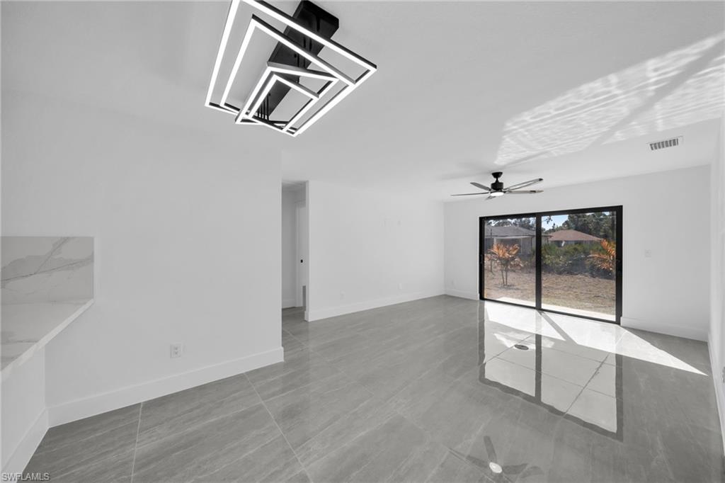 Unfurnished room with baseboards and a ceiling fan