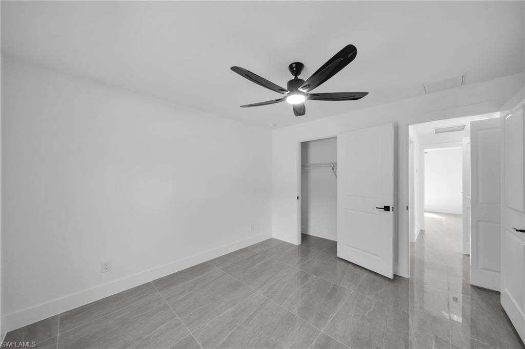 Unfurnished bedroom featuring a ceiling fan and a closet