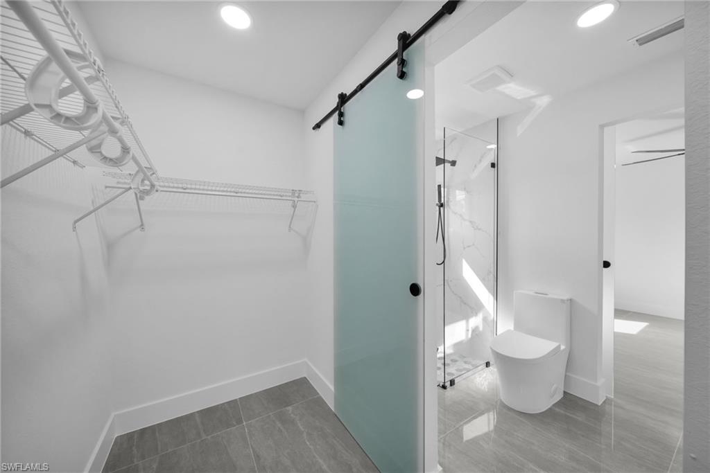 Walk in closet featuring a barn door