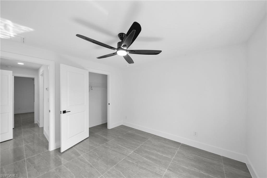 Unfurnished bedroom with a closet and a ceiling fan