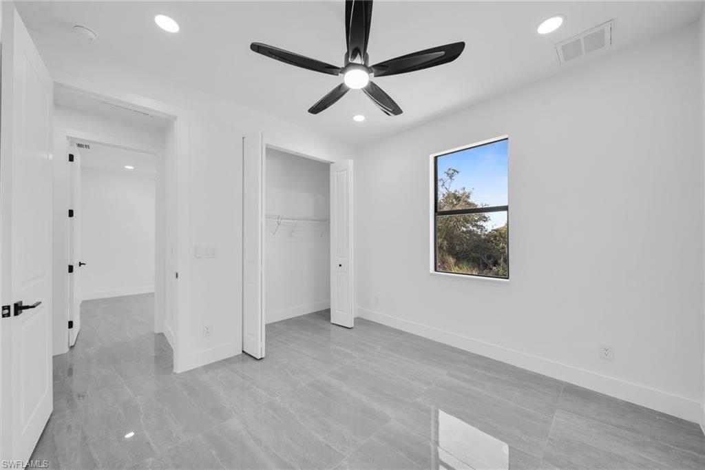 Unfurnished bedroom with ceiling fan, recessed lighting, and a closet