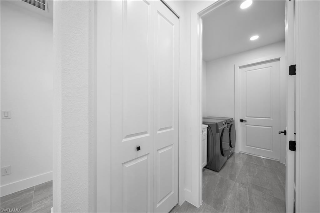 Laundry room featuring washer and dryer and recessed lighting