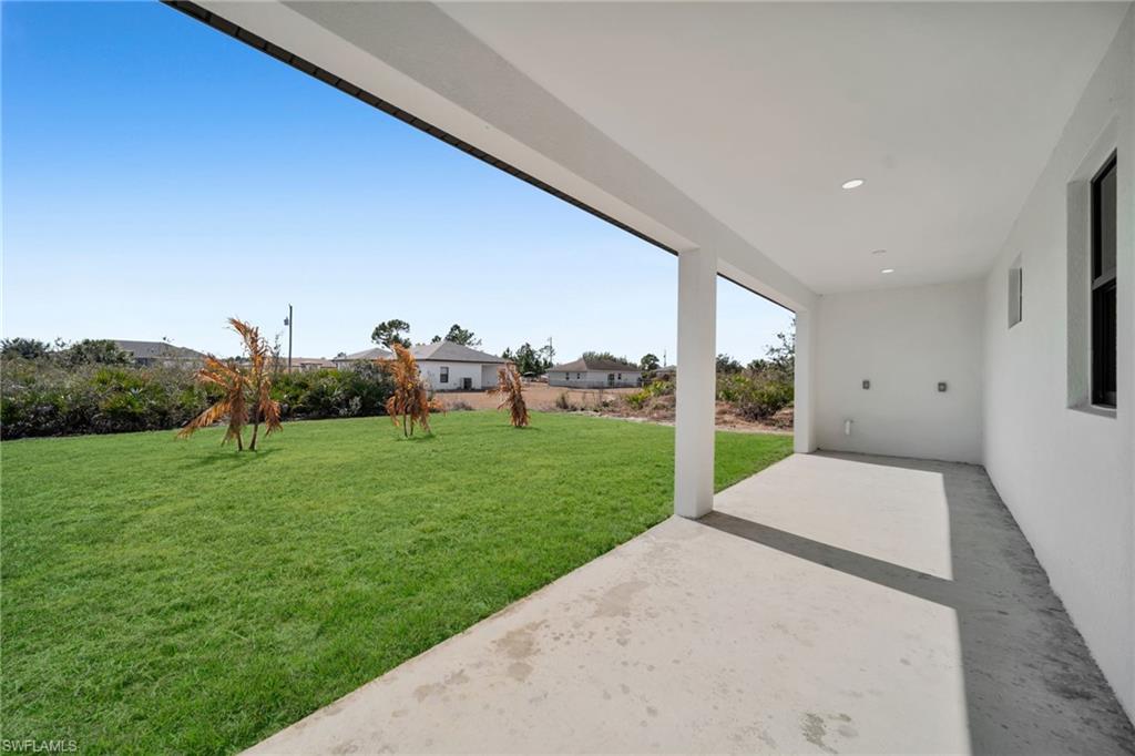 View of grassy yard with a patio