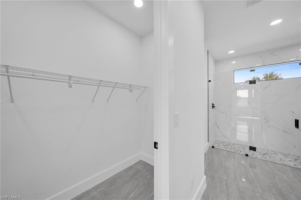 Laundry area with baseboards and recessed lighting