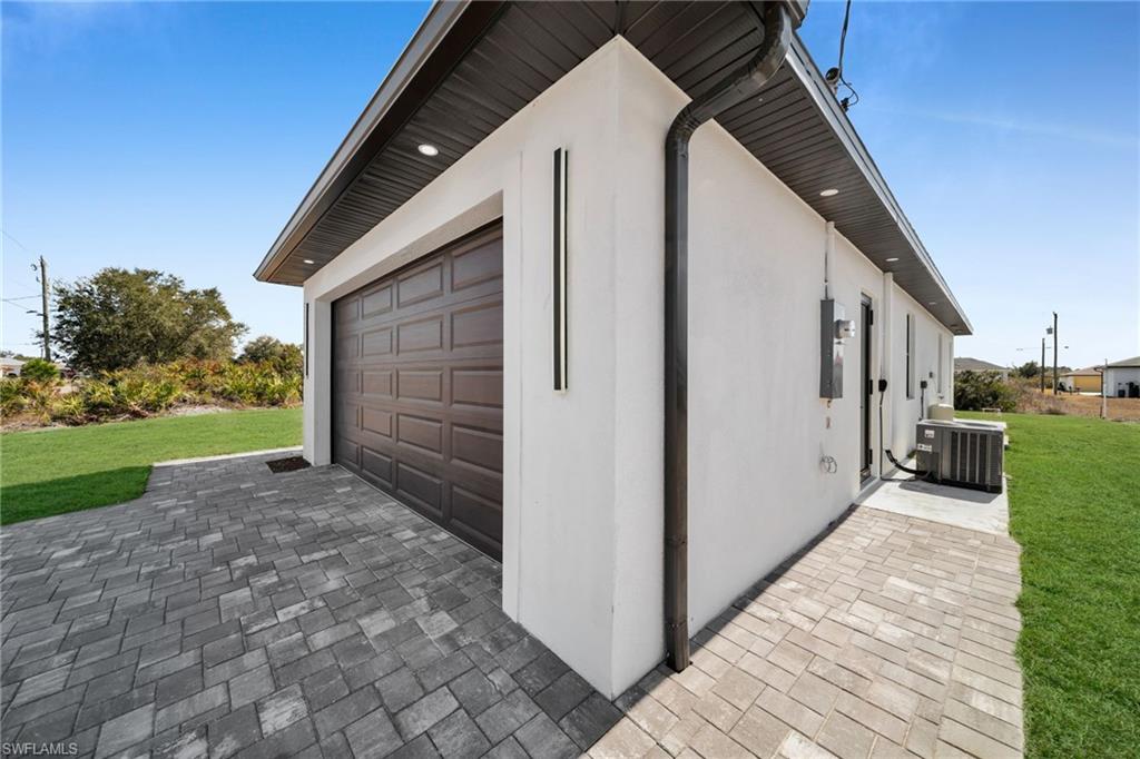 View of property exterior featuring a yard and stucco siding