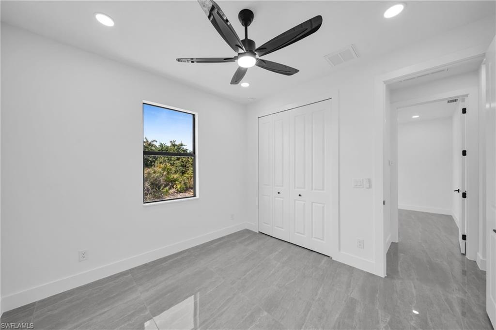 Unfurnished bedroom with a closet, a ceiling fan, and recessed lighting