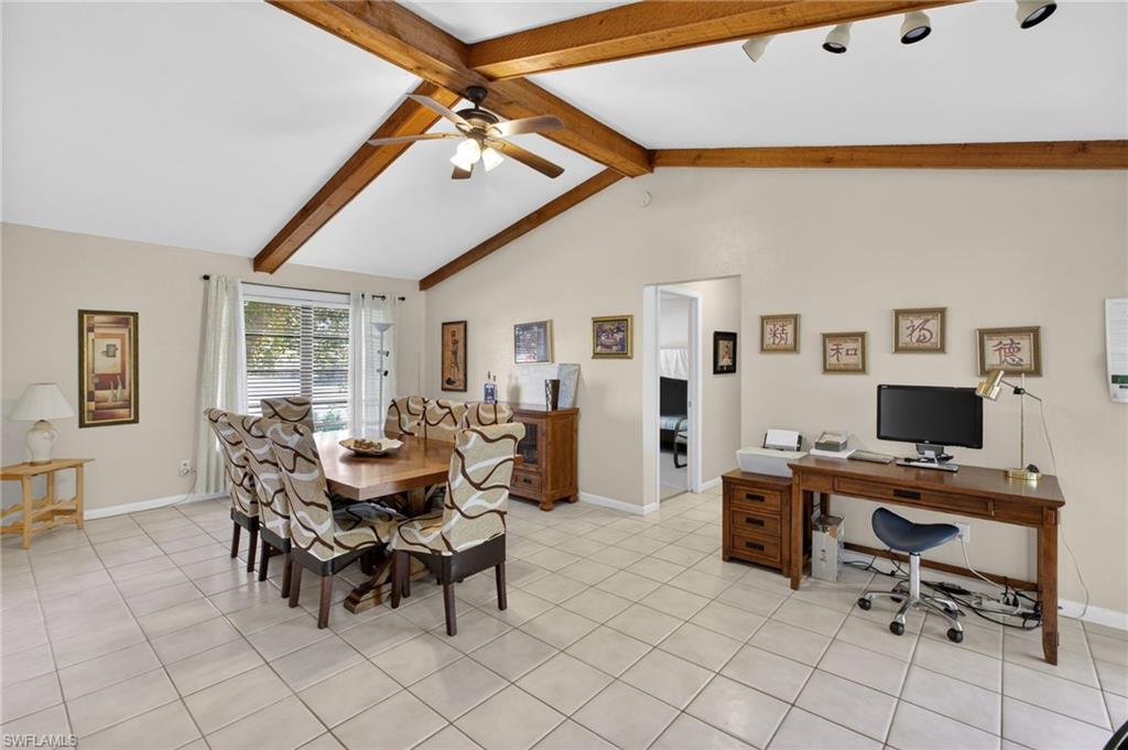 Dining room with ceiling fan, light tile patterned flooring, and an office area