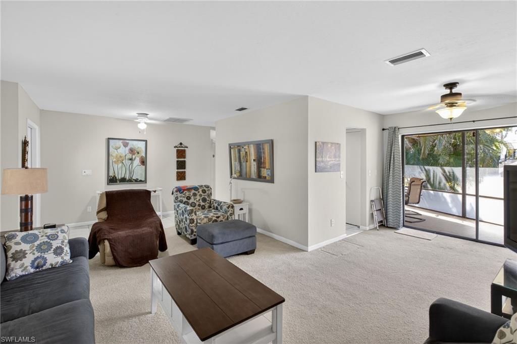 Living room featuring a ceiling fan and carpet flooring