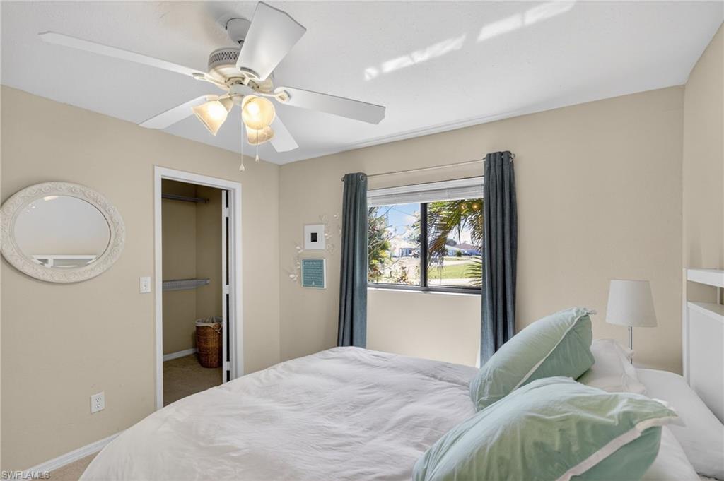Bedroom with ceiling fan and carpet floors