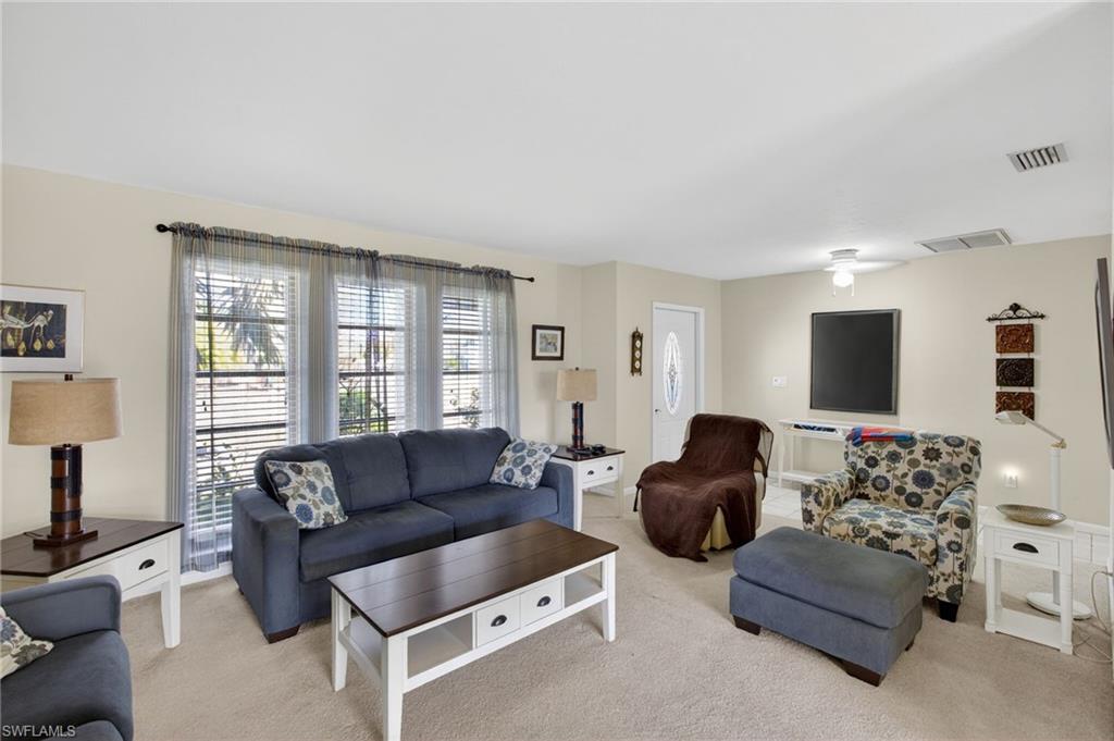 Living room featuring light carpet