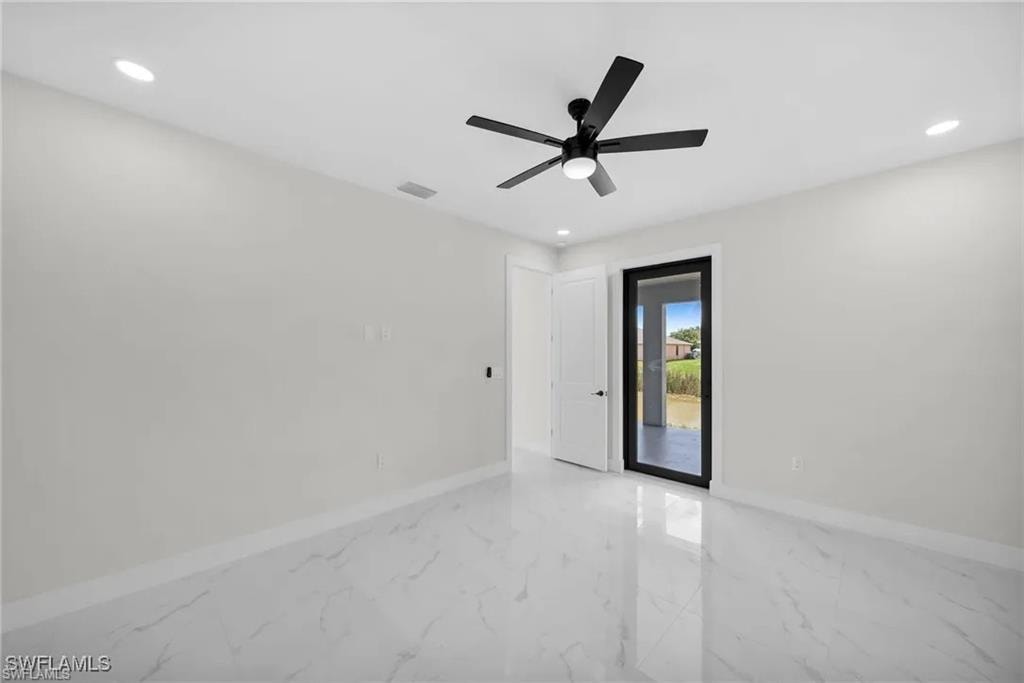 Empty room featuring light marble finish flooring, recessed lighting, and a ceiling fan