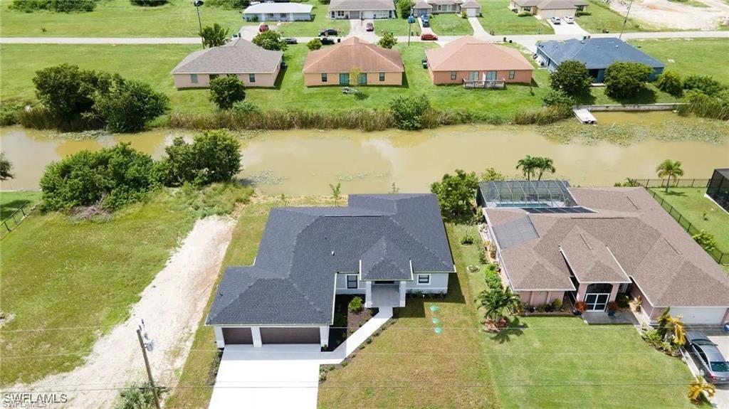 Aerial perspective of suburban area with a nearby body of water
