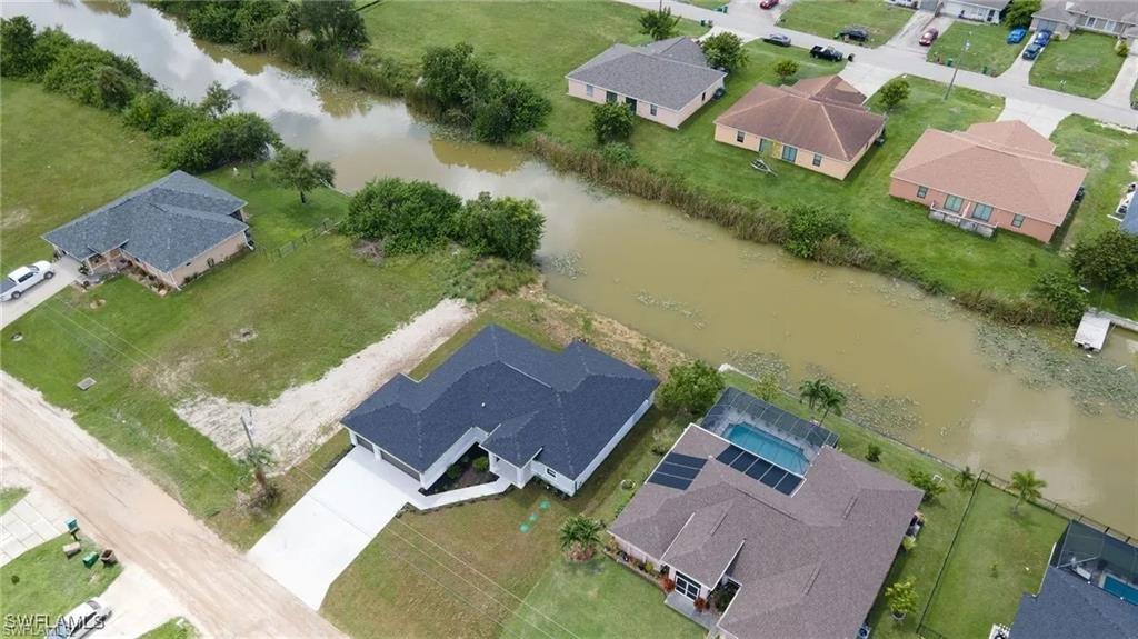 Aerial perspective of suburban area featuring a nearby body of water