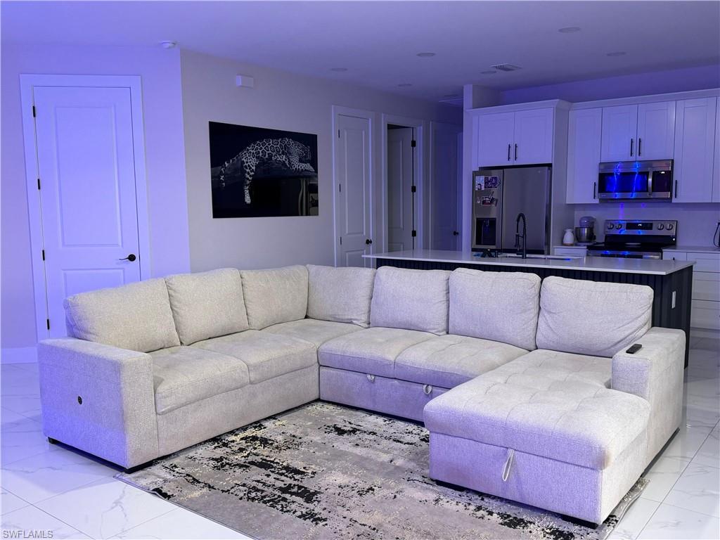 Living area with light marble finish floors