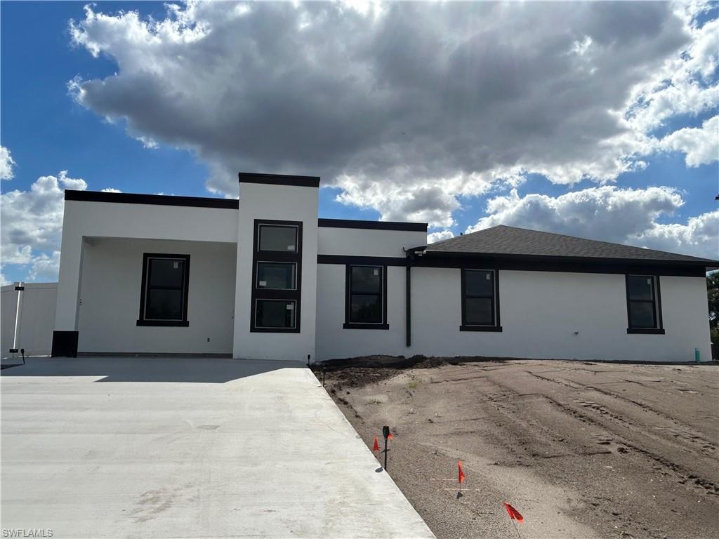View of front of house featuring stucco siding