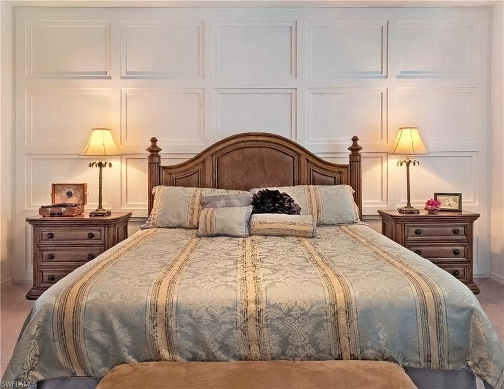 Bedroom featuring a decorative wall and carpet flooring
