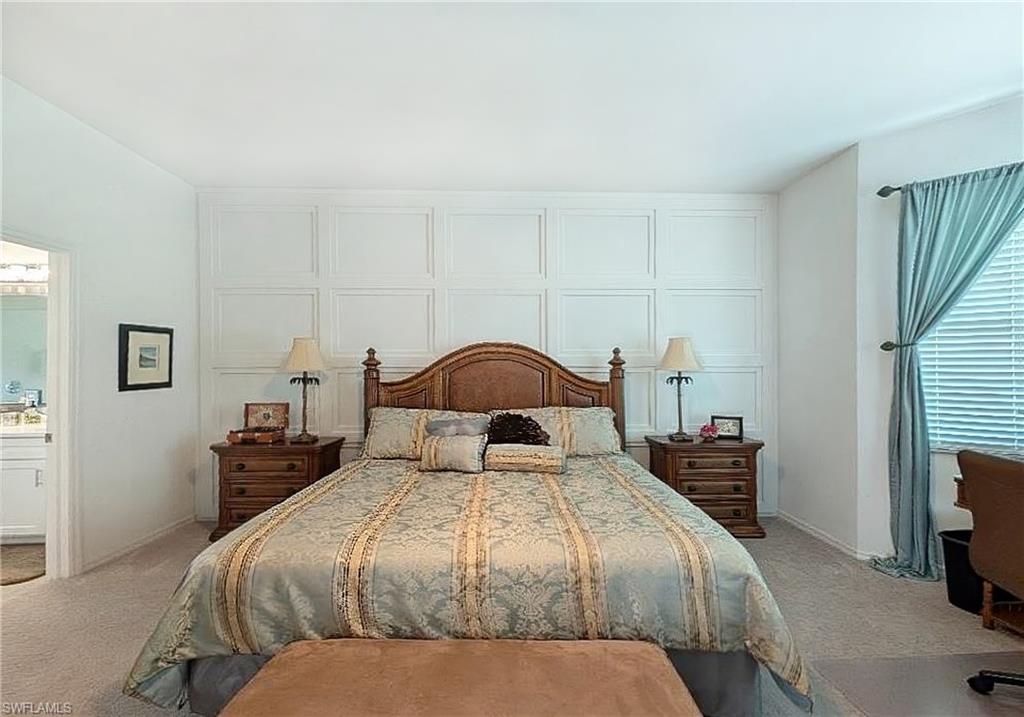 Bedroom with light colored carpet