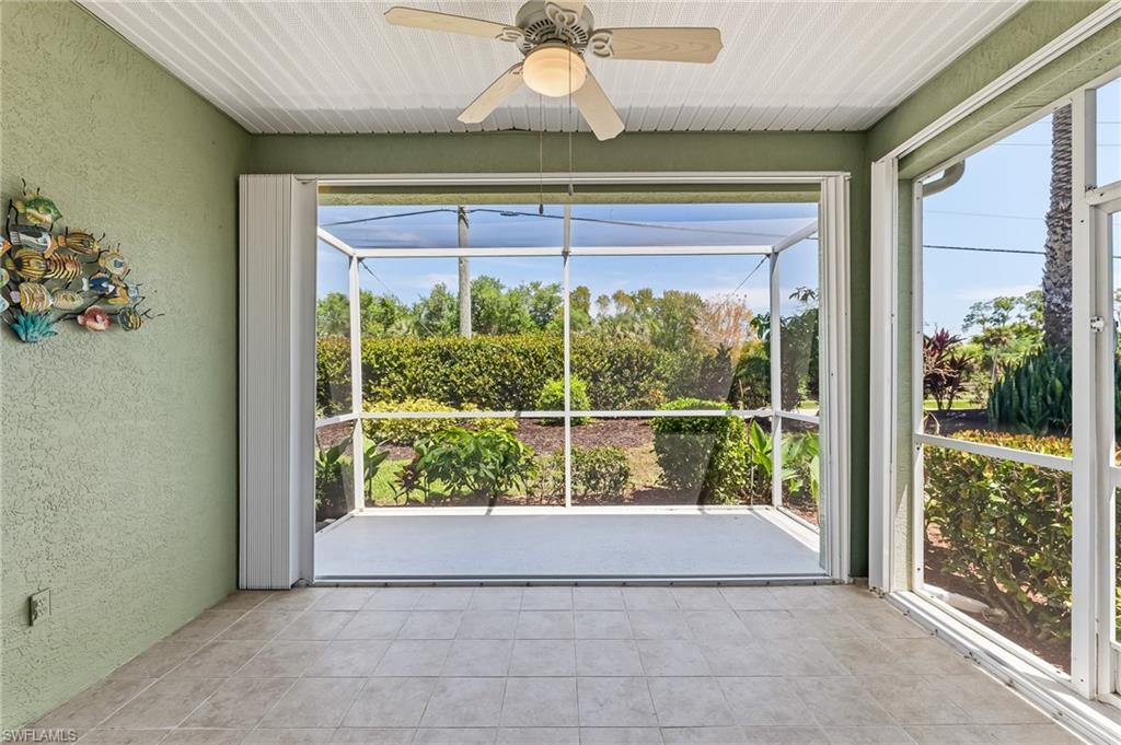 Extended Screened Lanai with tile/concrete flooring. Featuring beautiful big doors with glass inserts and side panels.  Accordian Shutters to protect home.