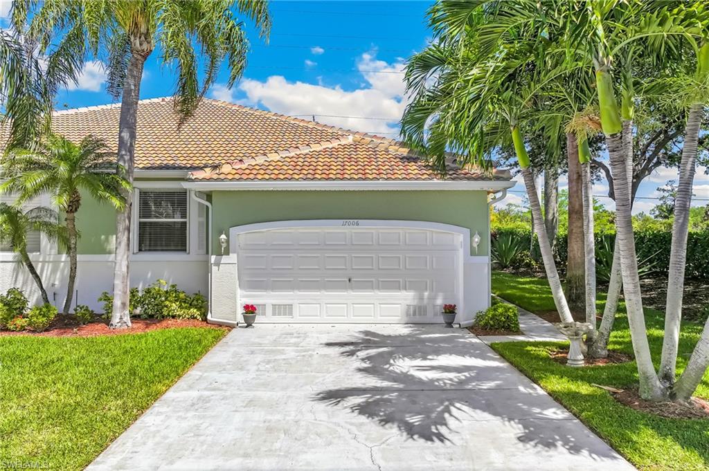East side of attached villa with lovely landscaping and privacy berm.