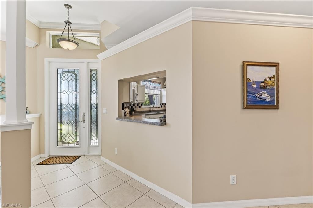 Lovely foyer with etched glass front door and side panel. Transom window above door.