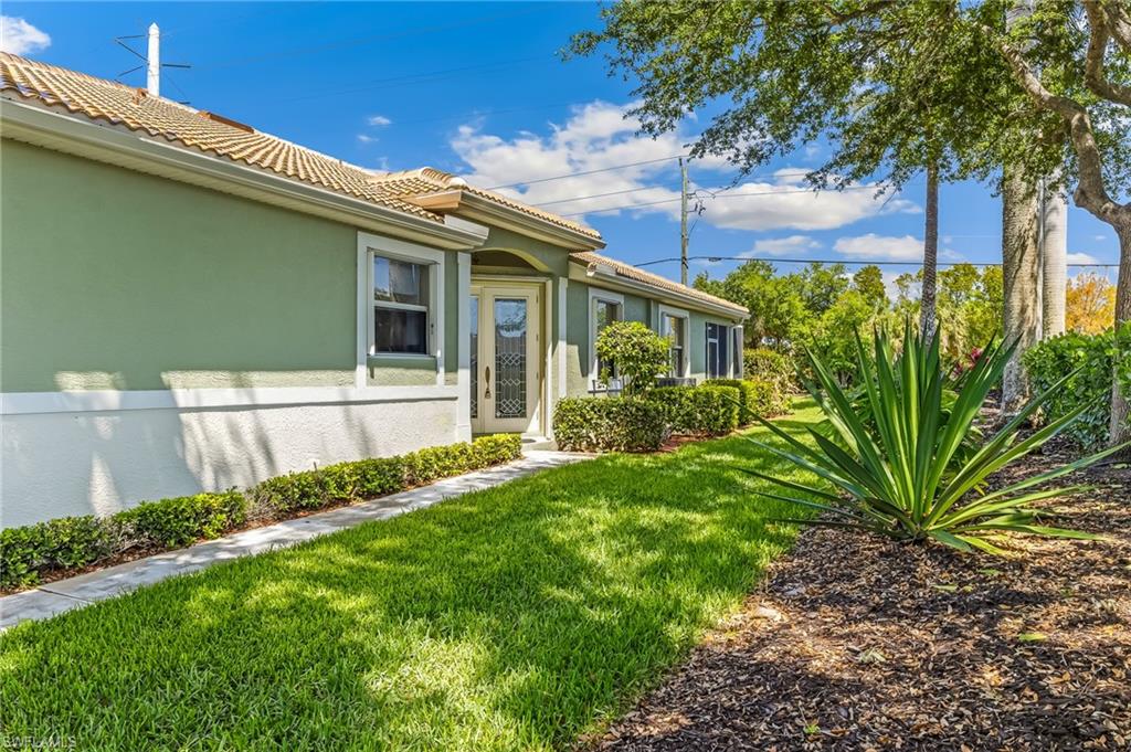 Lovely entrance on East side of home, impeccable landscaping and privacy hedge!
