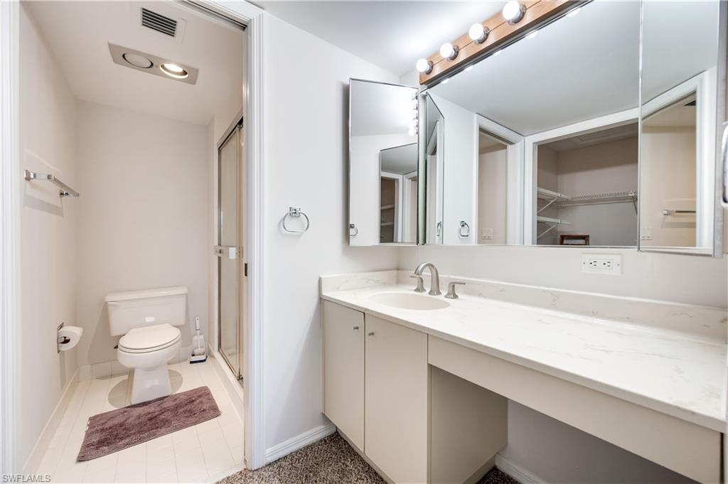 Bathroom with vanity and a stall shower