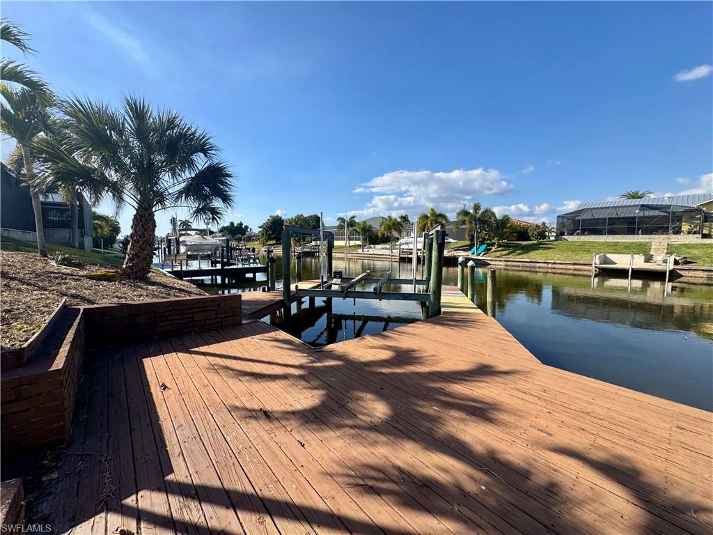 Dock area featuring boat lift and a water view