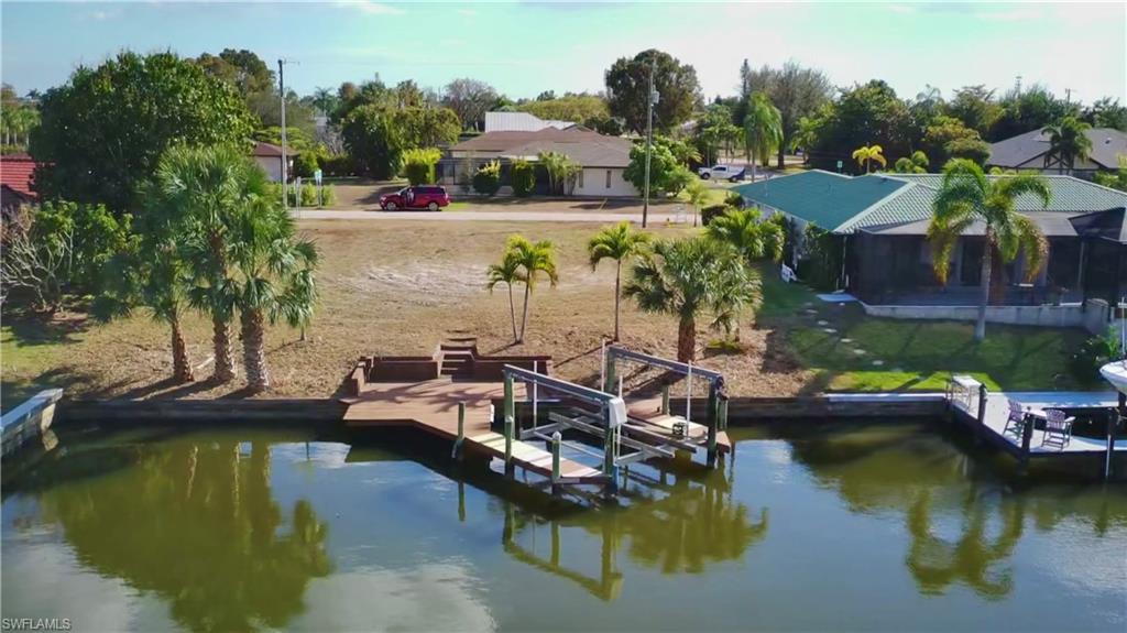 Dock area with boat lift and a water view