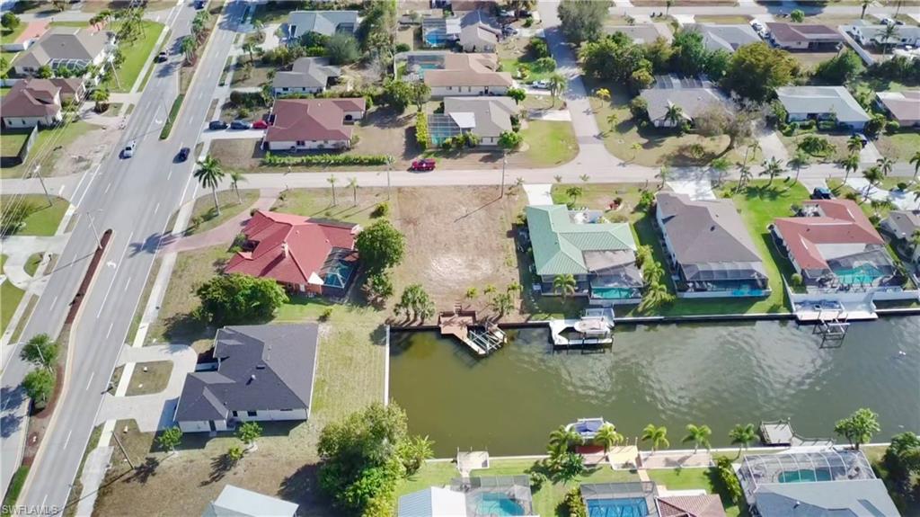 Aerial overview of property's location with nearby suburban area and a gulf access canal