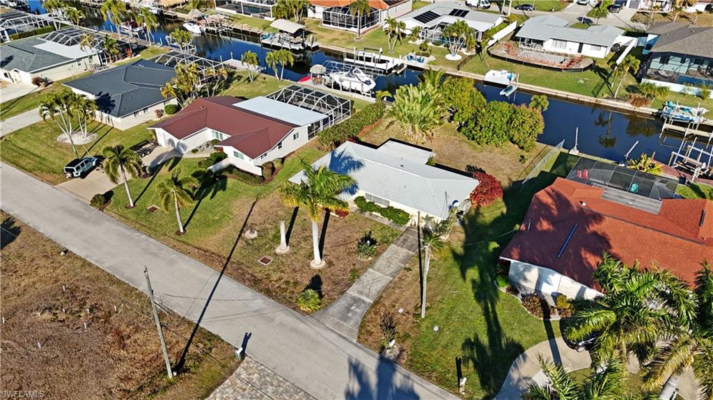 Aerial view of residential area featuring a nearby body of water