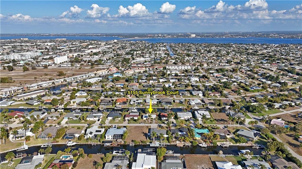 Aerial perspective of suburban area with a large body of water