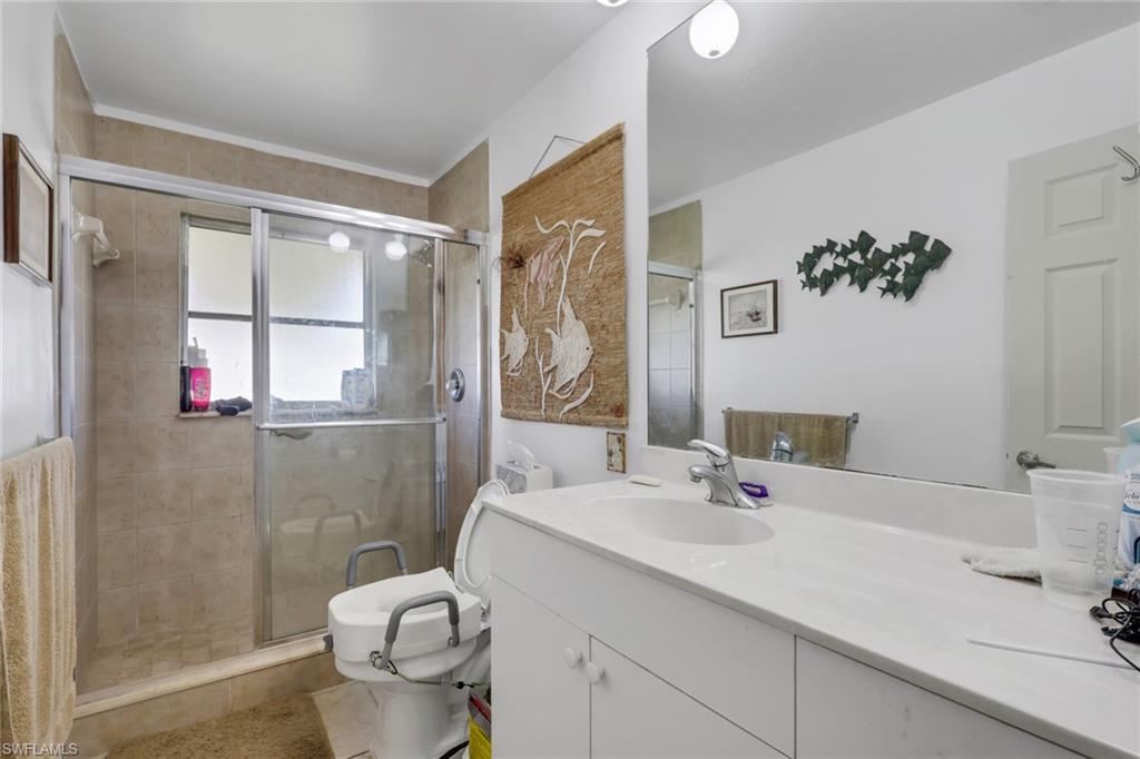 Full bathroom with vanity and a stall shower