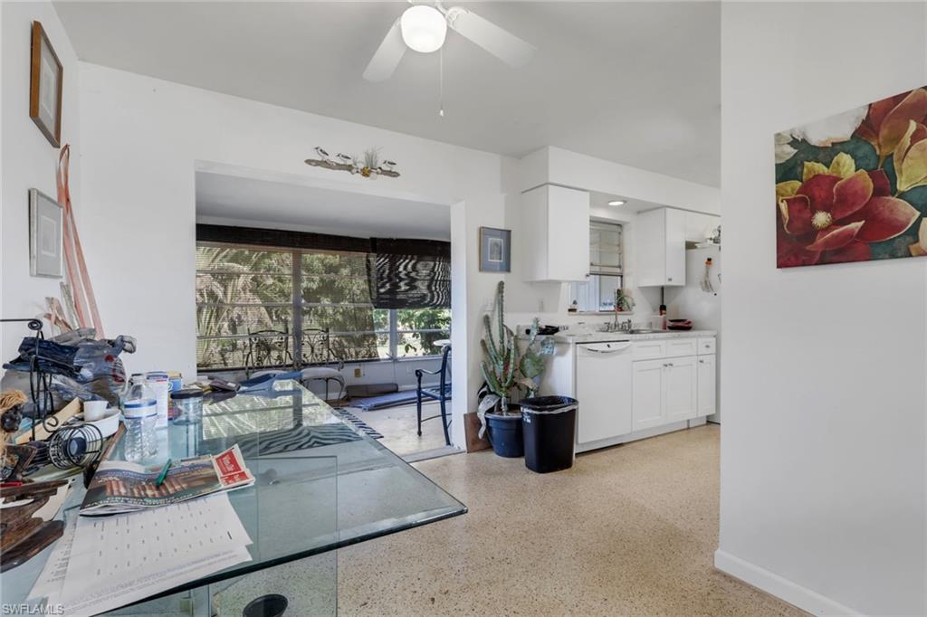 Dining space featuring dark speckled floor and a ceiling fan