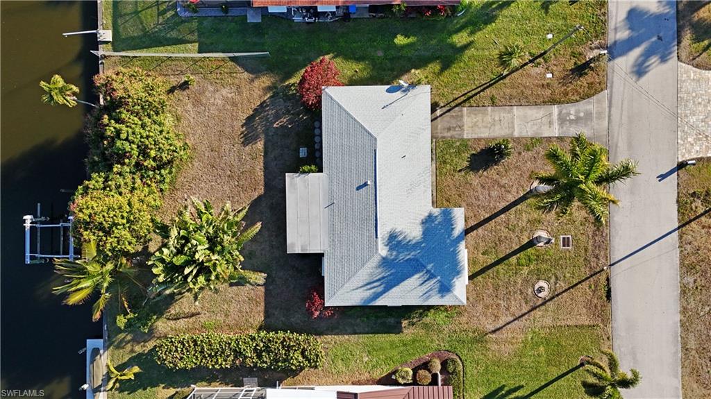 Aerial view of property and surrounding area featuring a large body of water