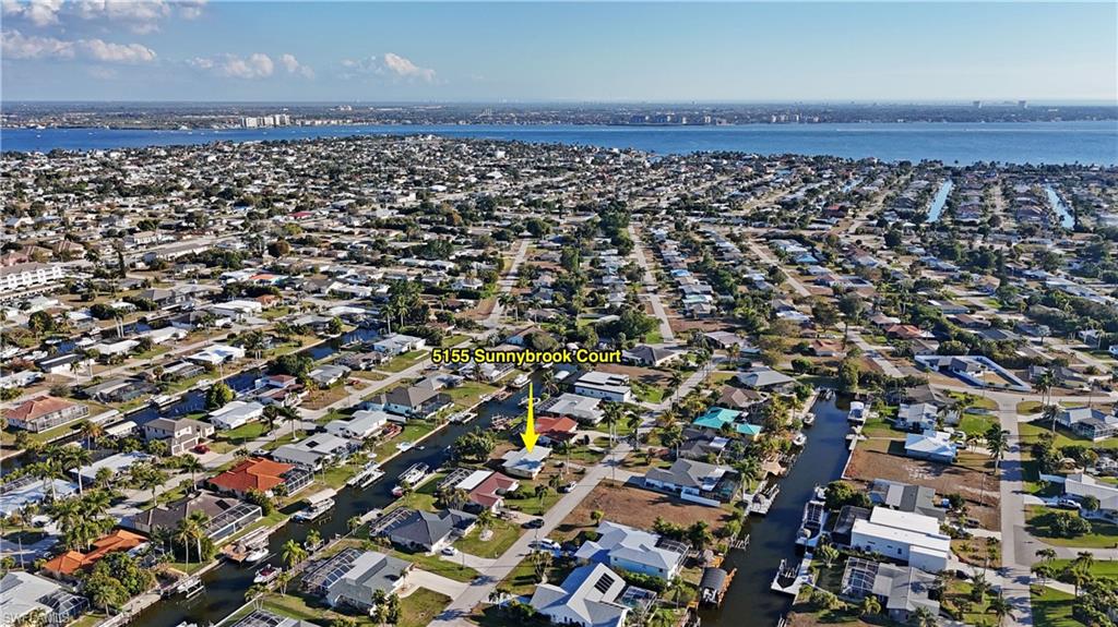 Aerial perspective of suburban area with a large body of water