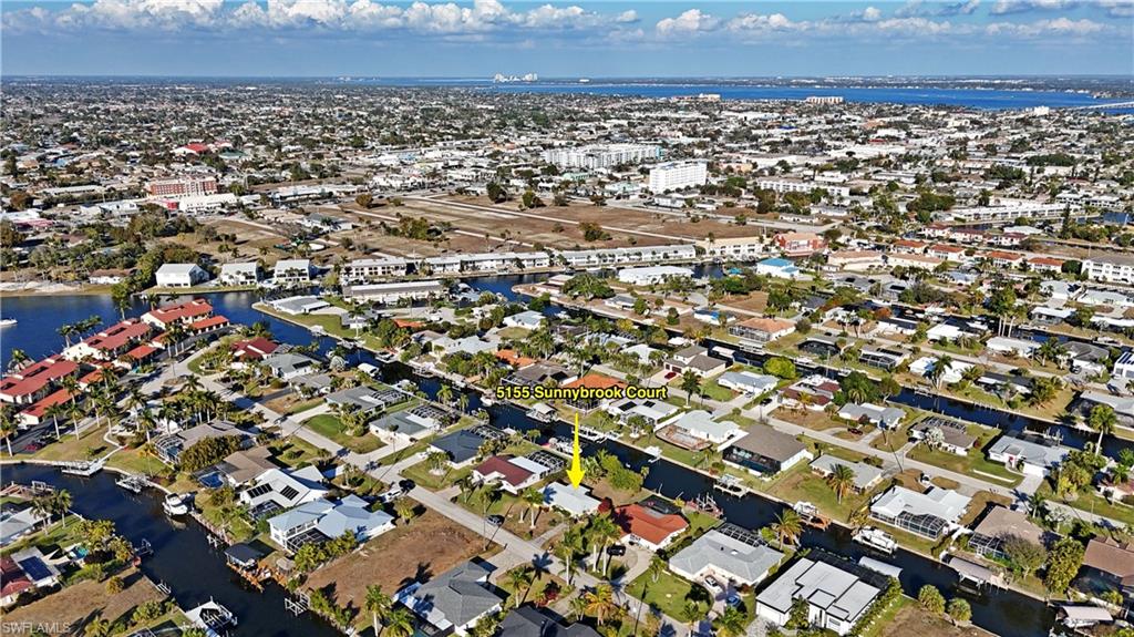 Aerial perspective of suburban area featuring a large body of water