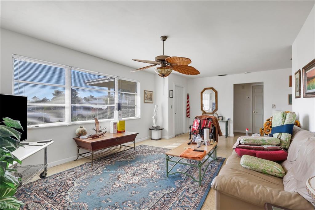 Living room with ceiling fan and baseboards