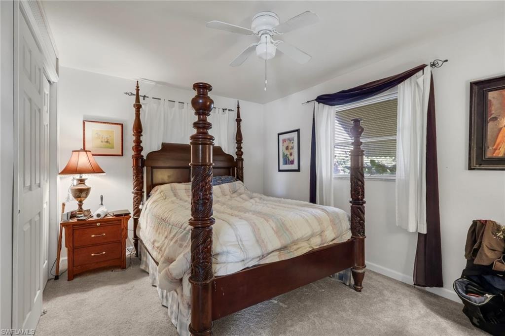 Bedroom with carpet floors, ceiling fan, and a closet