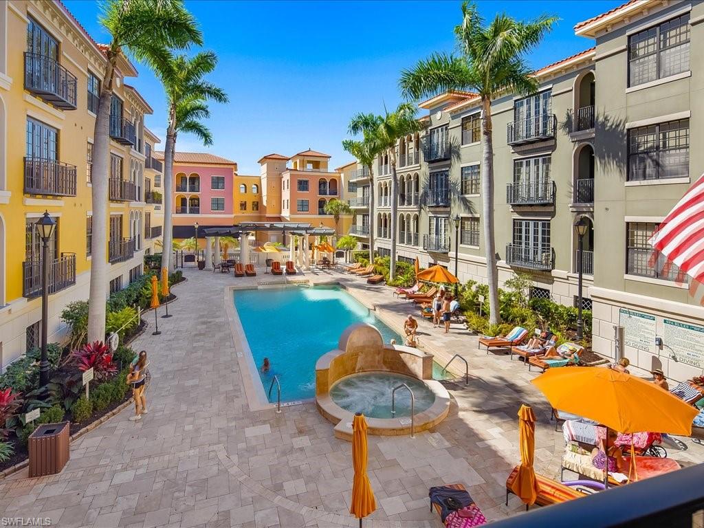 Community pool featuring a hot tub and a patio
