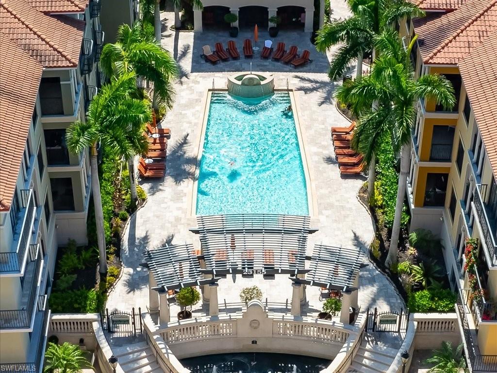 Community pool with a patio area and a community hot tub