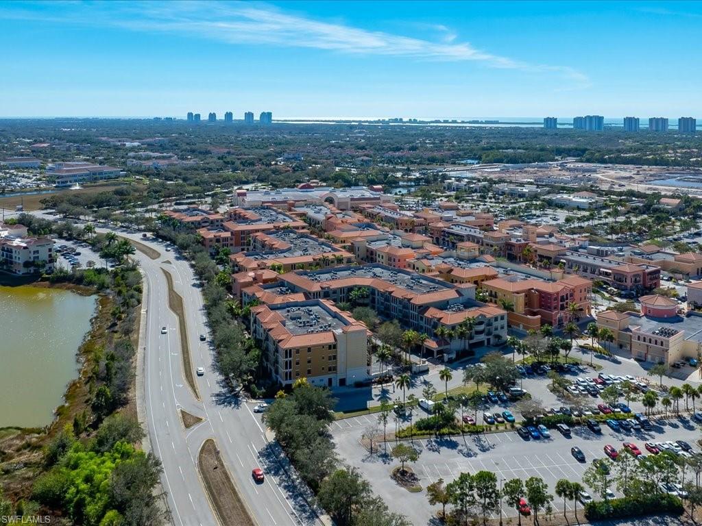 Aerial view of property's location featuring city skyline and a nearby body of water