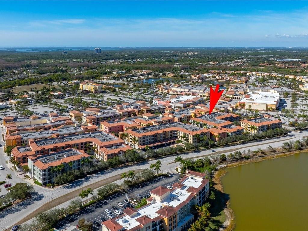 Aerial view of property and surrounding area featuring a large body of water