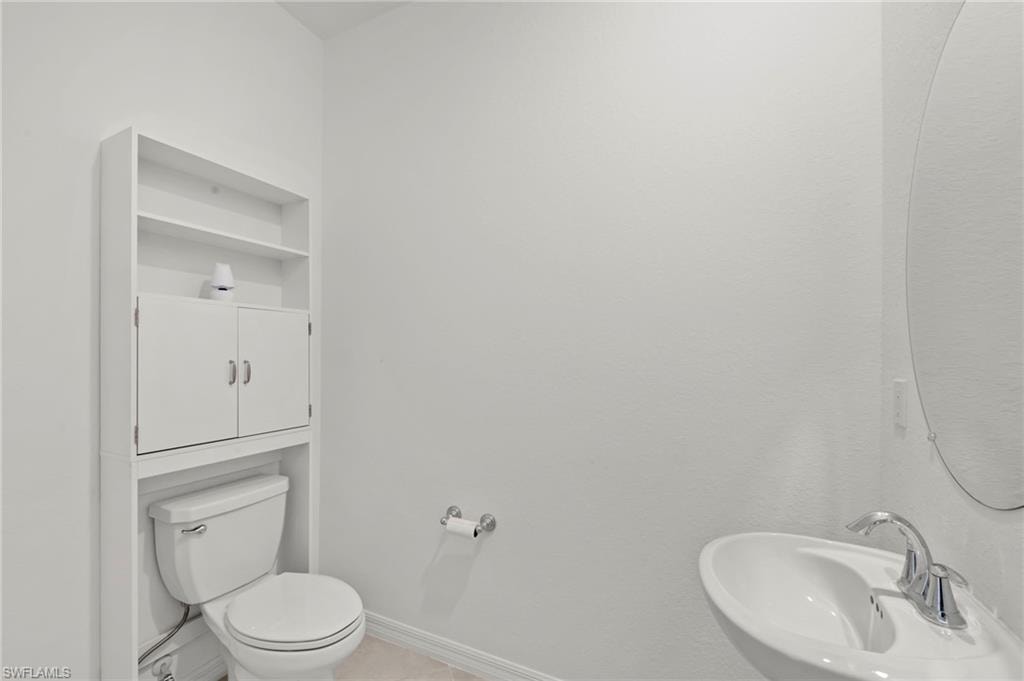 Half bath featuring toilet and a sink