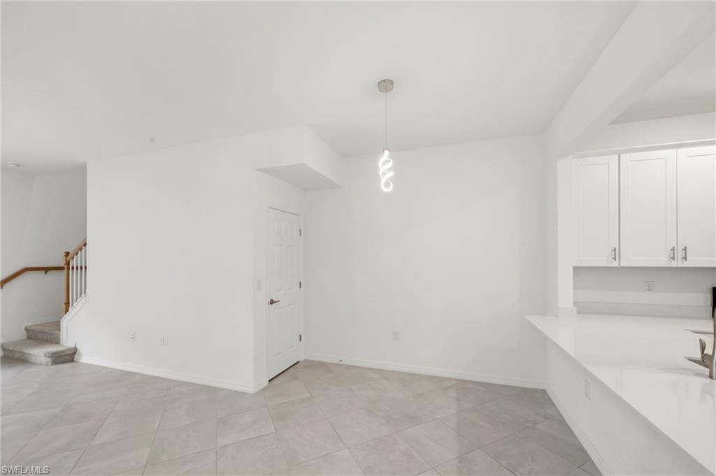 Unfurnished dining area with light tile patterned flooring