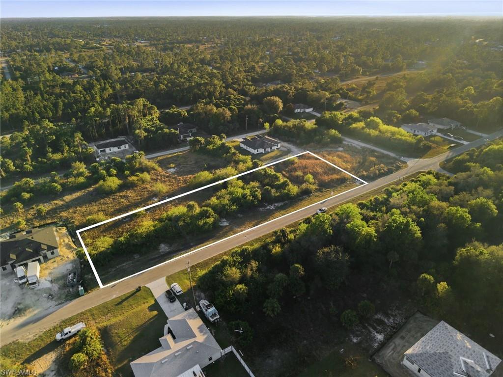 Aerial view of property's location featuring a forest and property parcel outlined